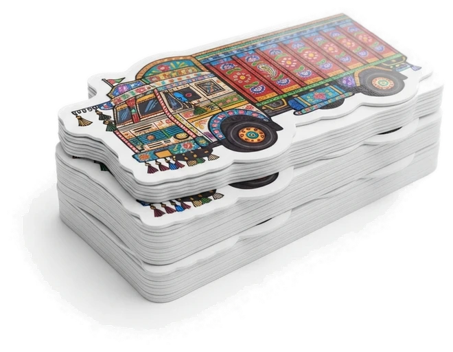 A stack of die-cut stickers of a decorated Indian truck, each cut to the truck's outline
